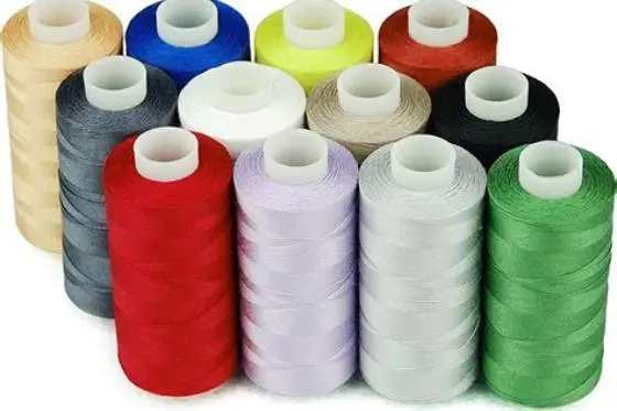 close-up of sewing machine needle stitching quilting thread