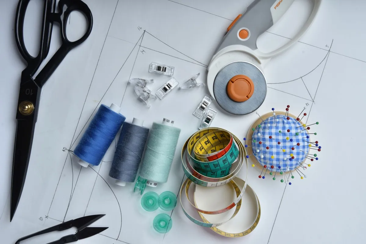 Sewing pattern pieces and fabric on a table